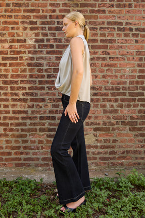 Woman wearing Du & Berry Grey Twist Collared Top paired with black wide-leg pants outdoors
