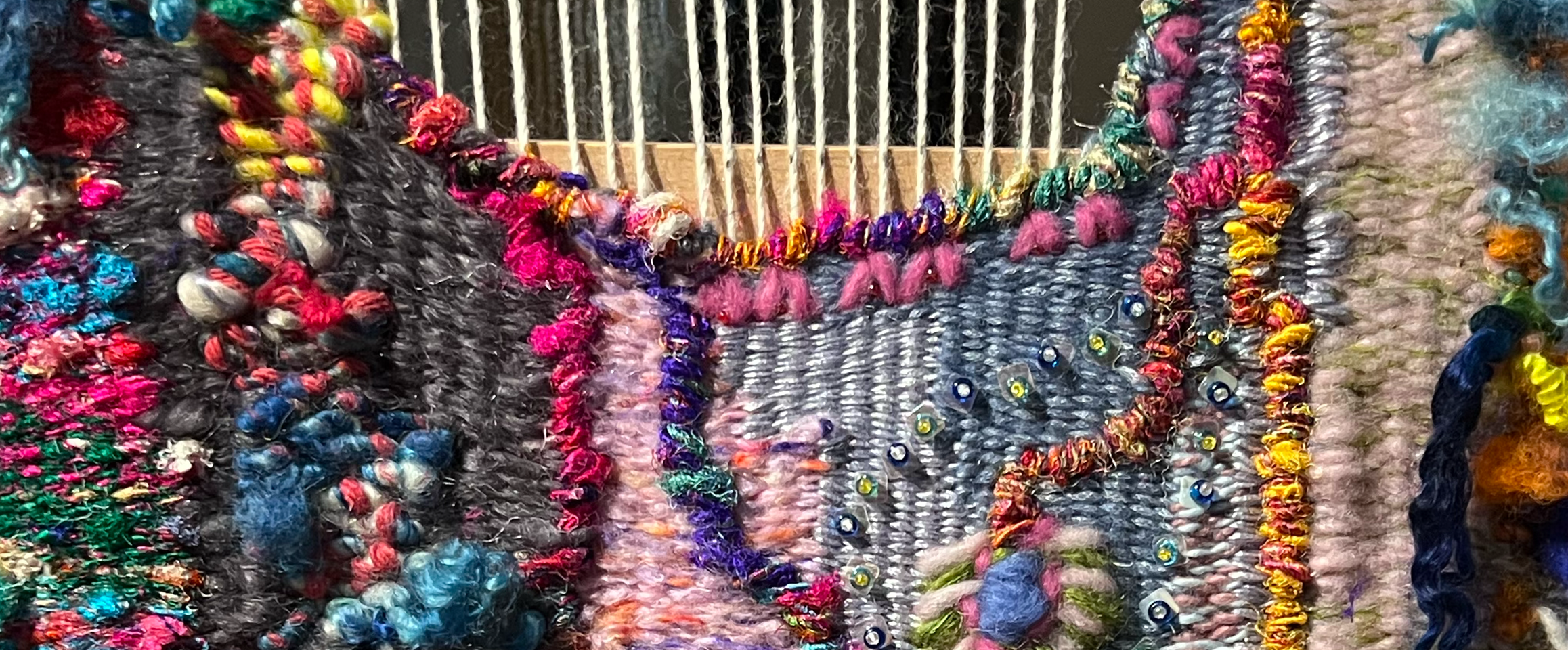 Close-up of colorful textured fabric art showcasing eco-friendly Earth Day fashion ideas