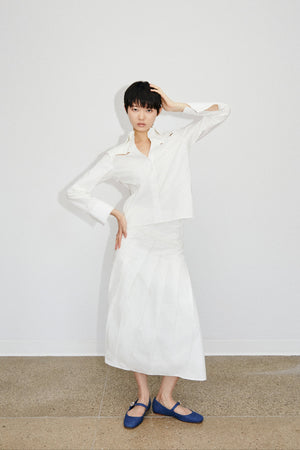 Front image of model wearing Du & Berry Du Cotton Poplin Button up white skirt and shirt showcasing the hand pleated details