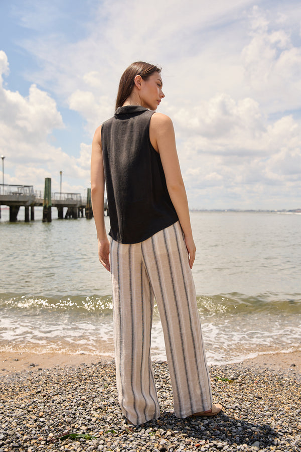 Du & Berry wide leg beach pants for women with vertical stripes worn by a woman at the beach
