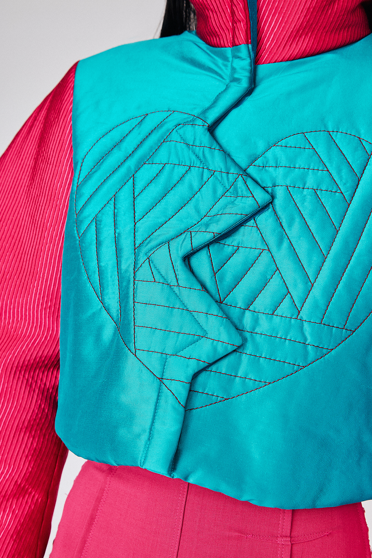 Detail shot of model wearing Du & Berry's Electronic Heart Silk Bomber Jacket with embroidery detail