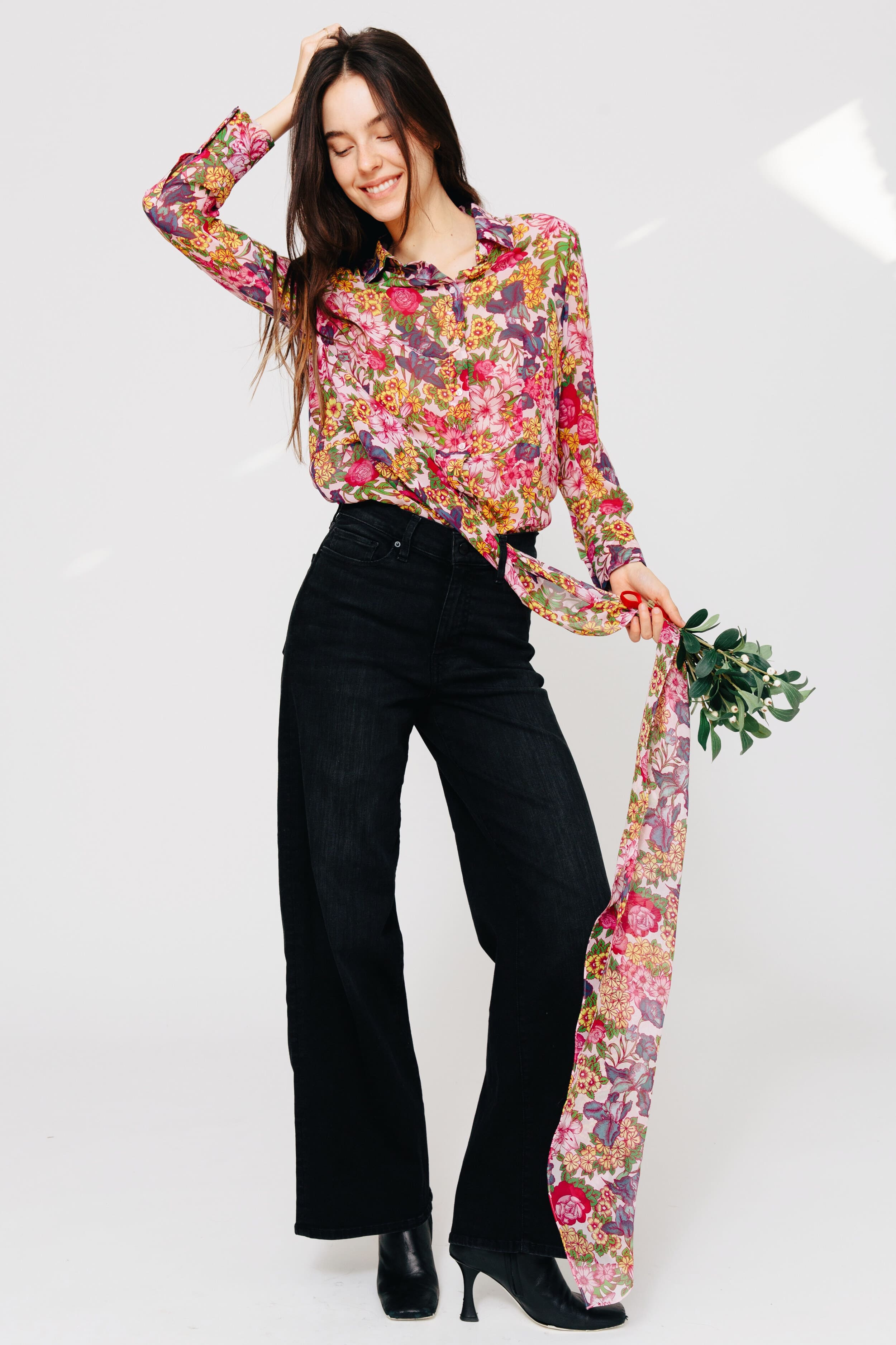 Model wearing Floral Symphony Silk Chiffon Blouse holding mistletoe