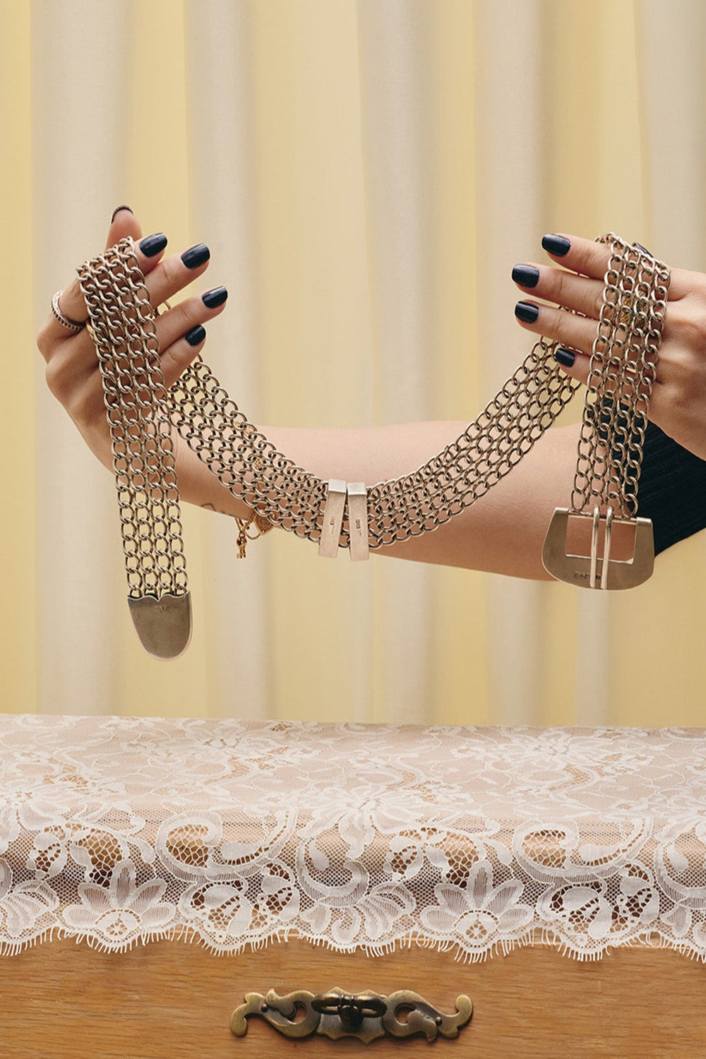 Du & Berry curated vintage - full view of  sterling silver all-metal four-row chain belt being held by model buckled 