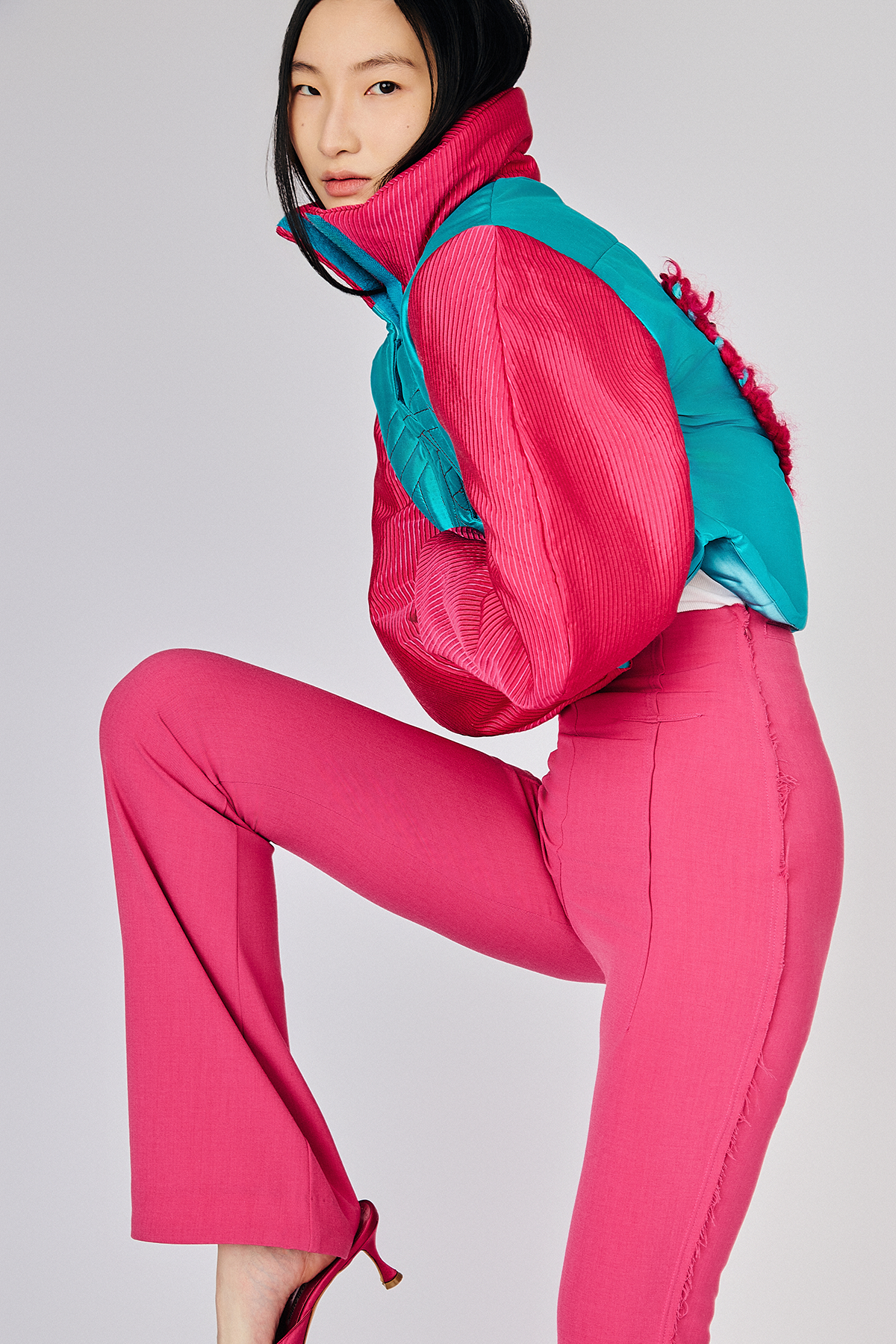 Model posing wearing pink pants with trendy Du & Berry One of a Kind Electronic Heart Silk Pink and Blue 80s-inspired Jacket