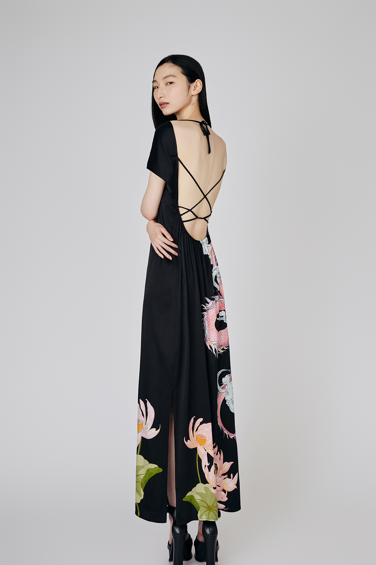 Full view of model showcasing the open back and tie details of Du & Berry's Loong Placement Print Warrioress Black Silk Midi Dress