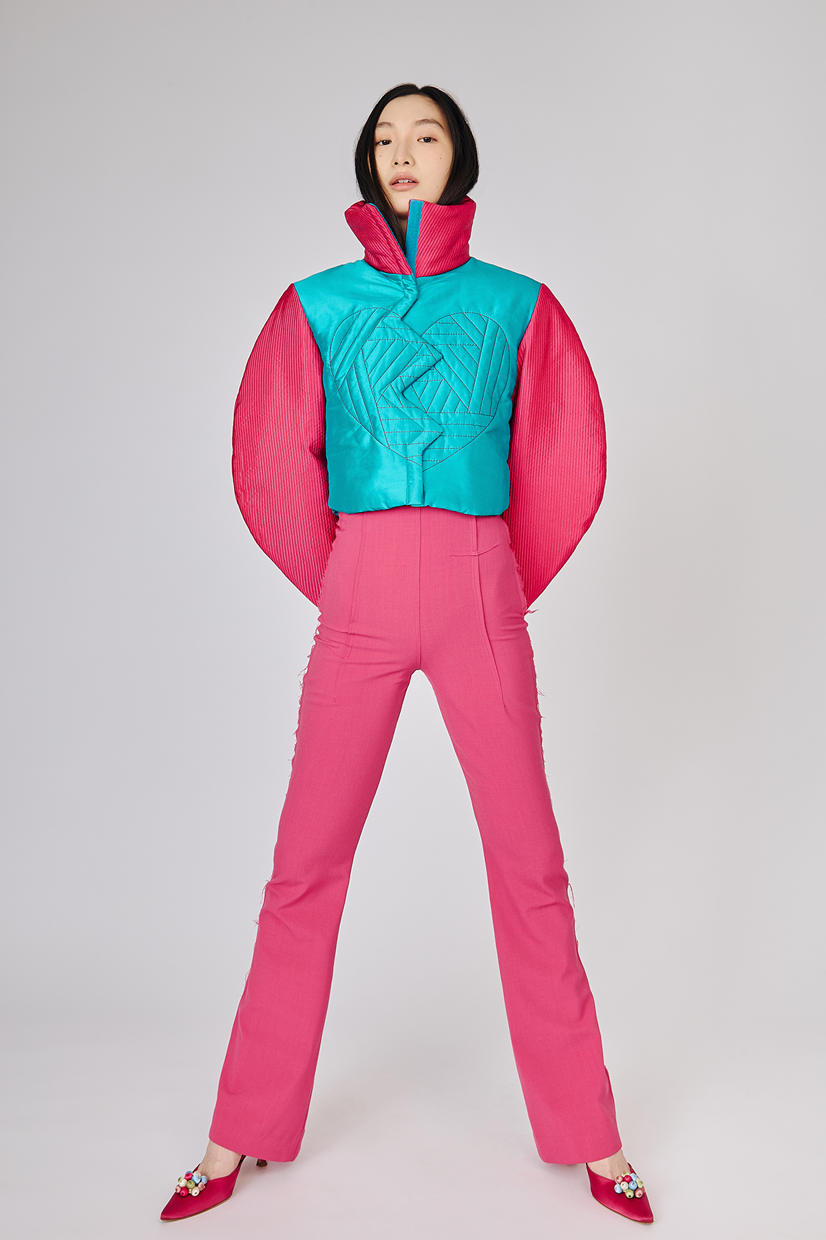 Model wearing trendy vibrant Electronic Heart Silk Bomber Jacket with funnel neck contrasting zipper