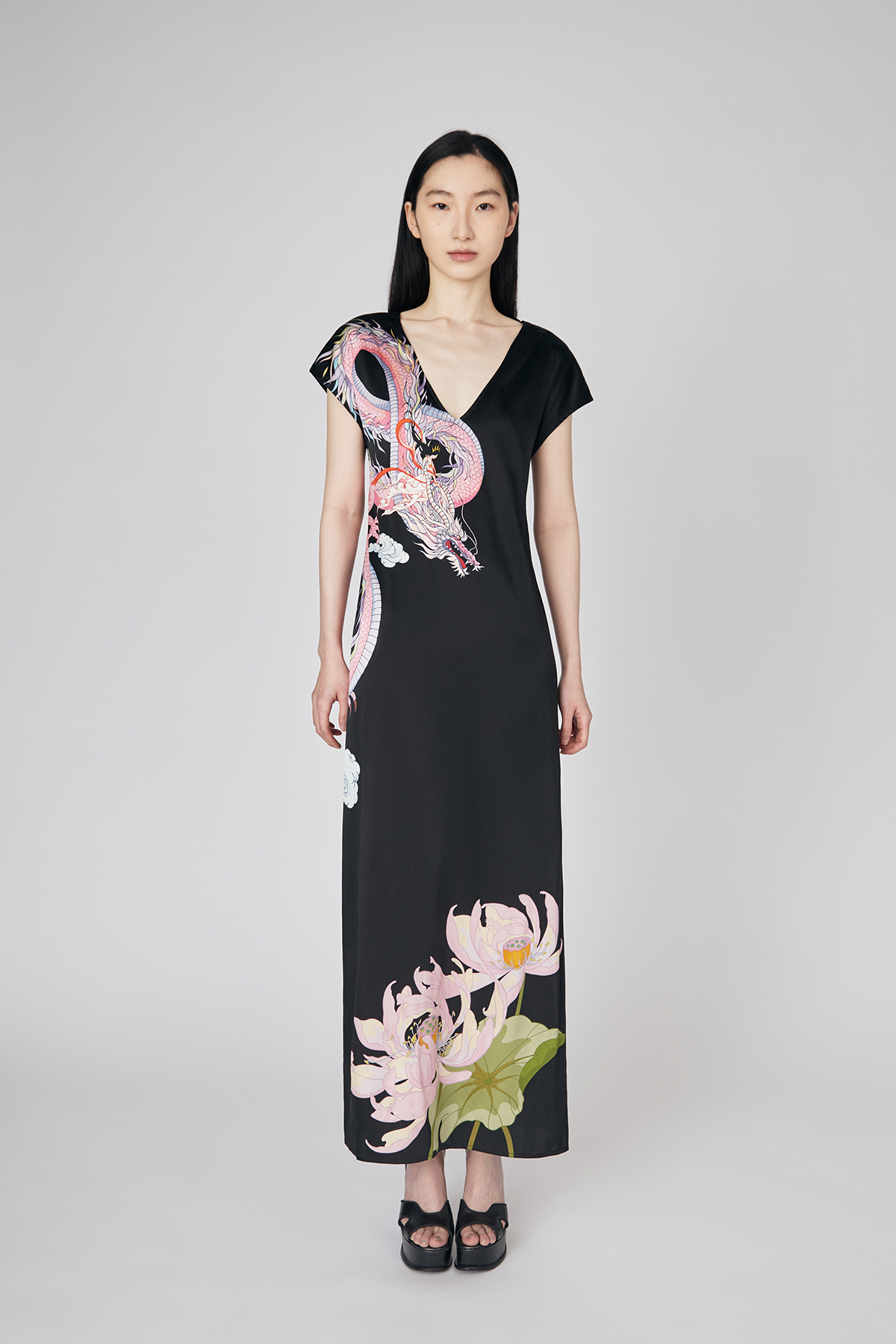 Full front view of model wearing black v-neck Loong Warrioress Placement Print Open-back Silk Dress