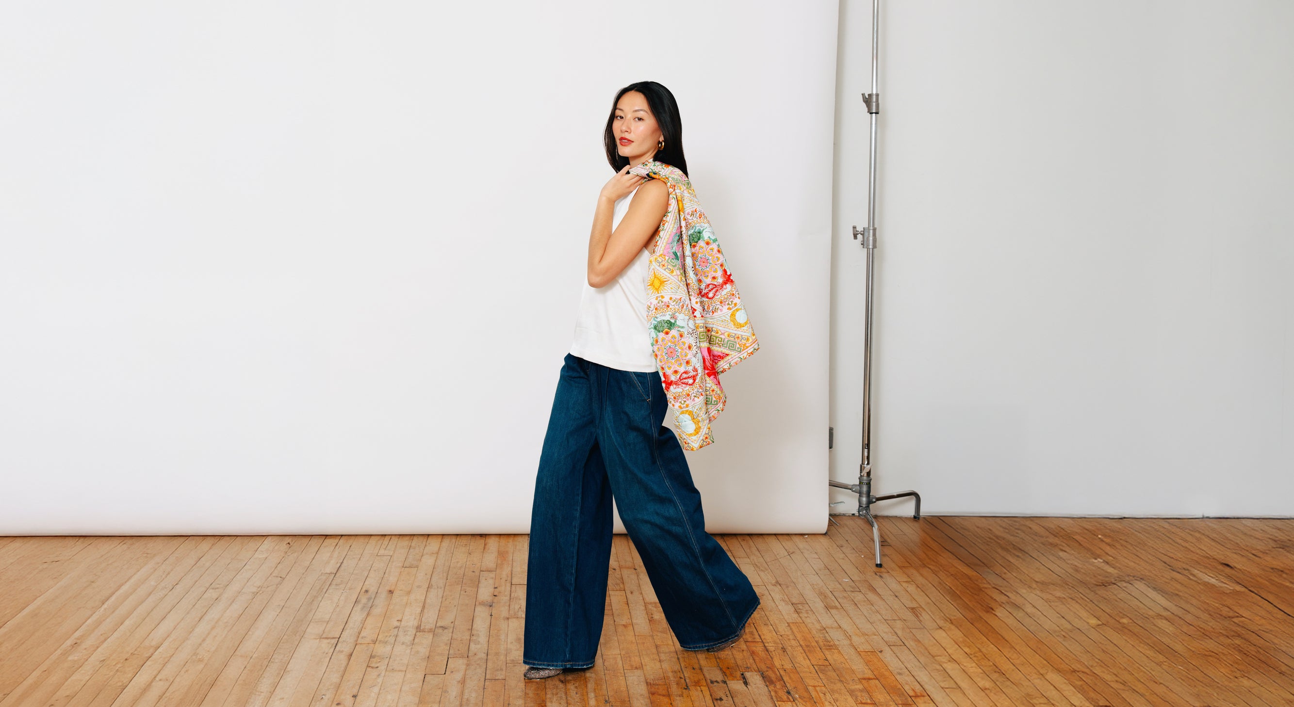 Model wearing Du & Berry Moonlight Silk Halter Top & Four Divine Creatures Jacket slung over shoulder for New Years positive feng shui and good luck