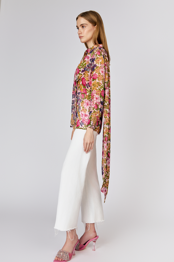 Side view of model wearing Du & Berry Floral Symphony Silk Chiffon Pink Button Up Blouse with scarf detail