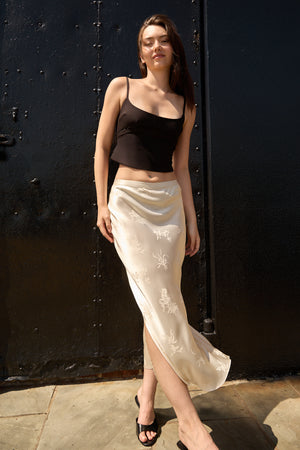 Beige Jacquard Long Skirt by Du & Berry worn by woman with black tank top and sandals