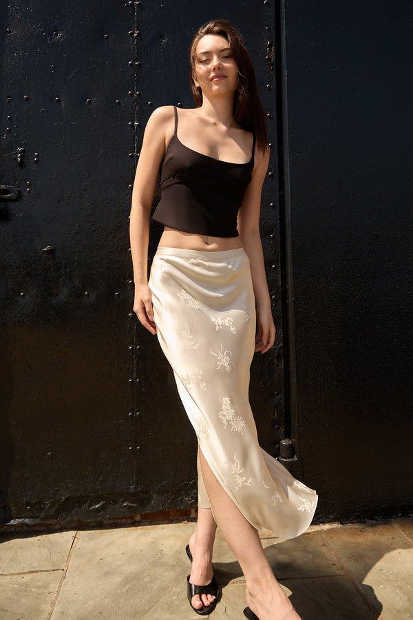 Beige Jacquard Long Skirt by Du & Berry worn by woman with black tank top and sandals