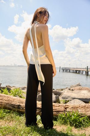 Du & Berry black elastic waistband comfort Straight Pants worn by woman standing by waterfront under blue sky