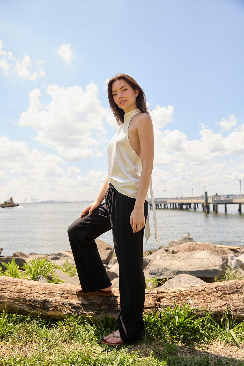 Woman wearing Du & Berry black elastic waistband comfort Straight Pants standing by the waterfront on a sunny day