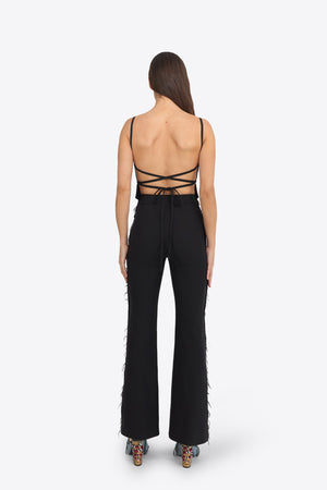 Du & Berry Black Flared Pants worn by model showing back view with strappy top and patterned heels