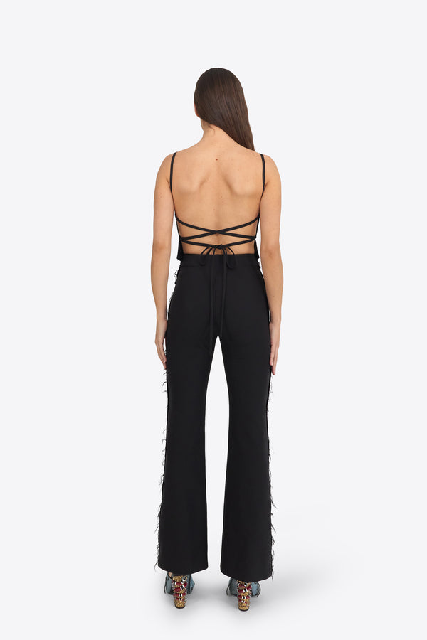 Du & Berry Black Flared Pants worn by model showing back view with strappy top and patterned heels