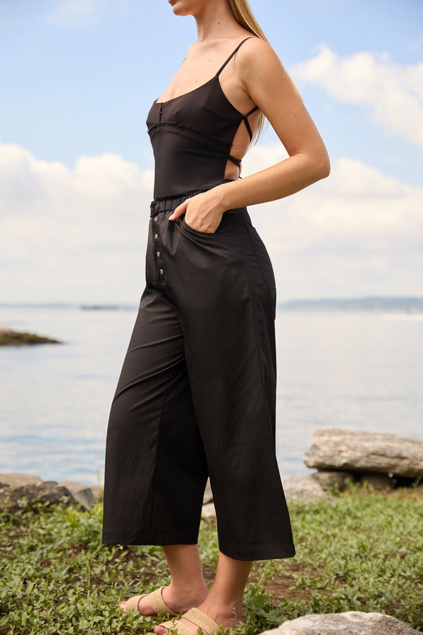 Du & Berry Cotton Palazzo Pants in Black styled with a black sleeveless top near a lakeside outdoors