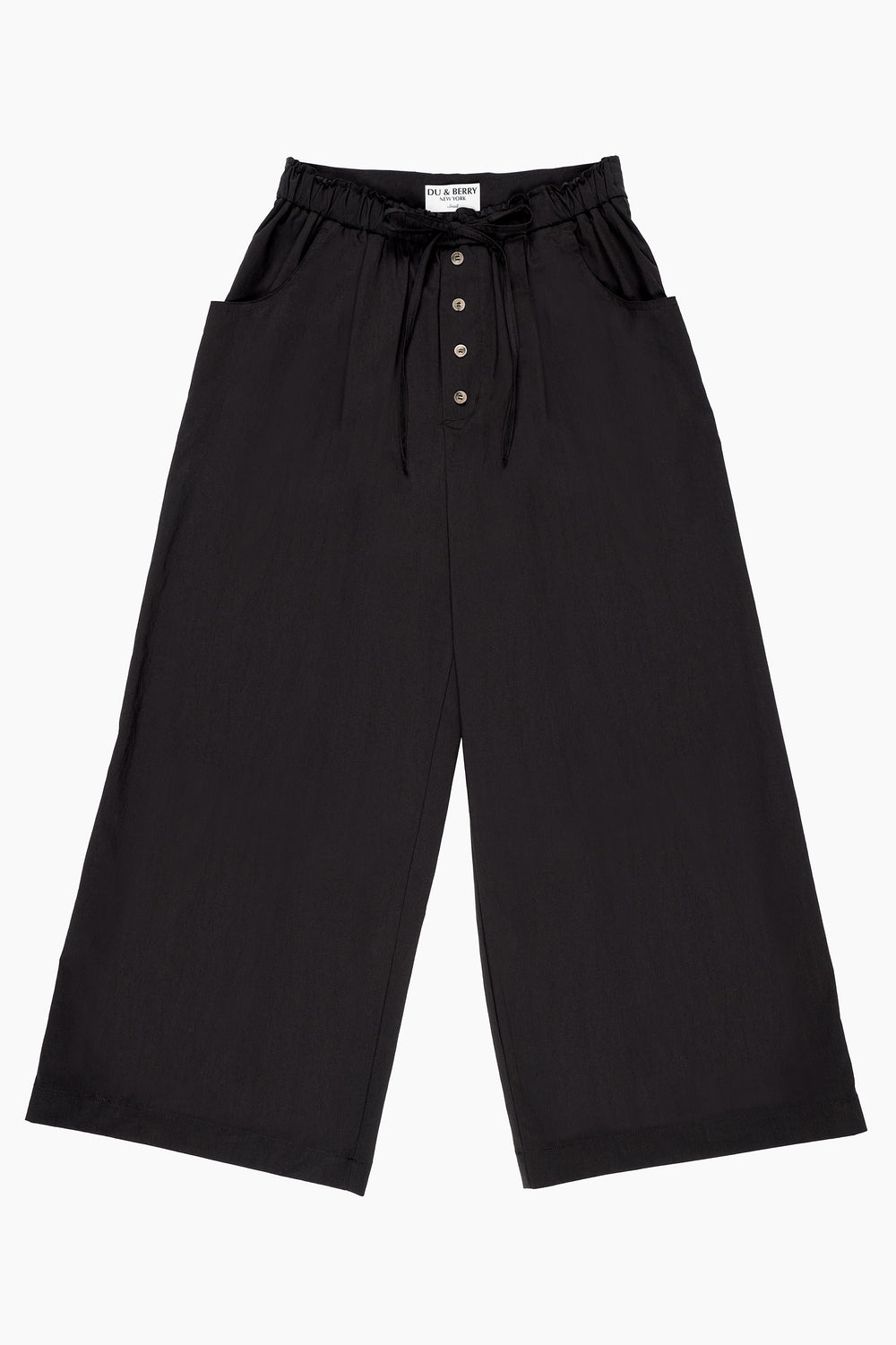 Du & Berry Cotton Palazzo Pants in Black worn by woman standing near water with a casual black top