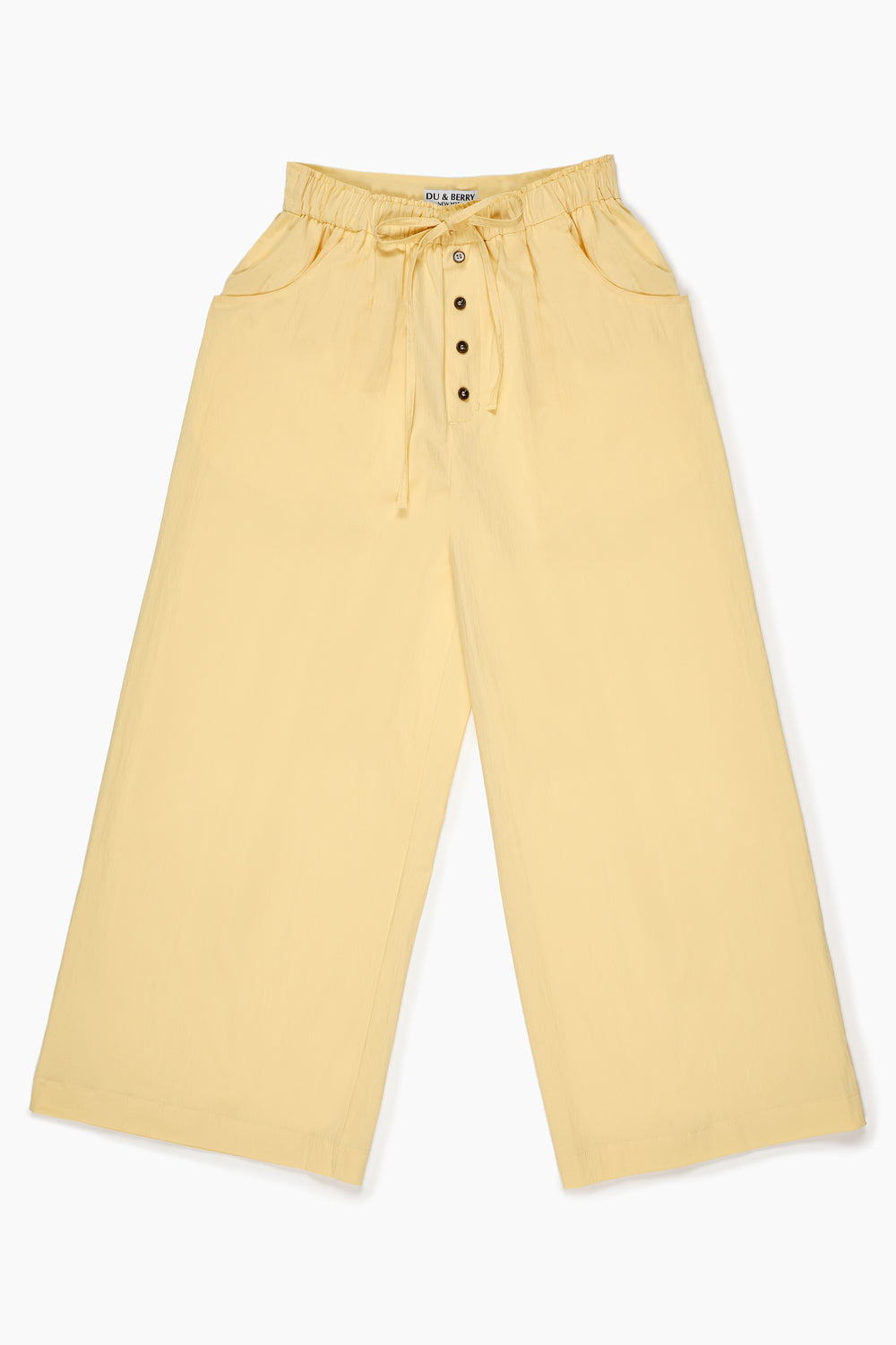 Du & Berry Cotton Palazzo Pants in Yellow with button details and drawstring waist worn by model outdoors