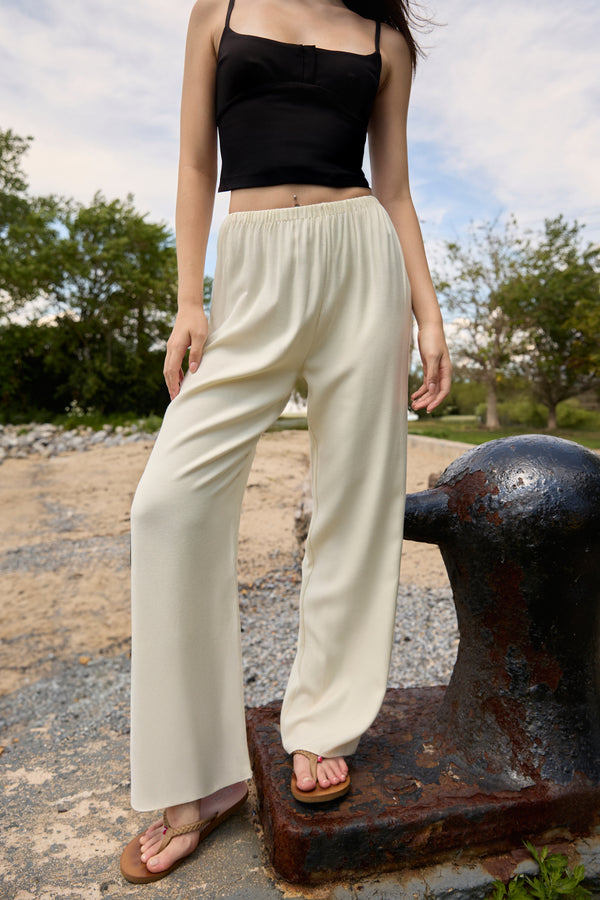 Du & Berry Cream Comfort Straight Pants worn by a woman with a black tank top outdoors