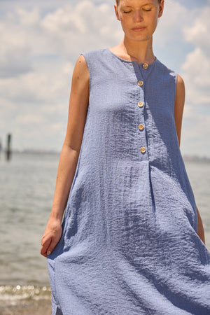 Du & Berry Blue Linen Button Midi Dress sleeveless with wooden buttons on light fabric by the water