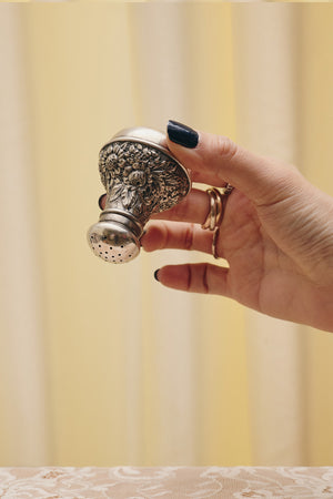 Du & Berry flower sterling silver shaker held in hand with intricate floral design