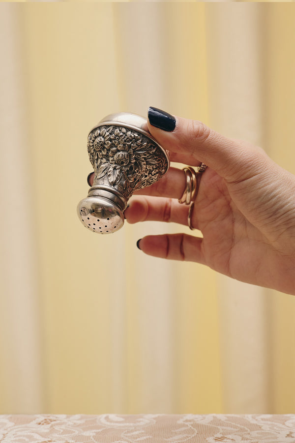 Du & Berry flower sterling silver shaker held in hand with intricate floral design