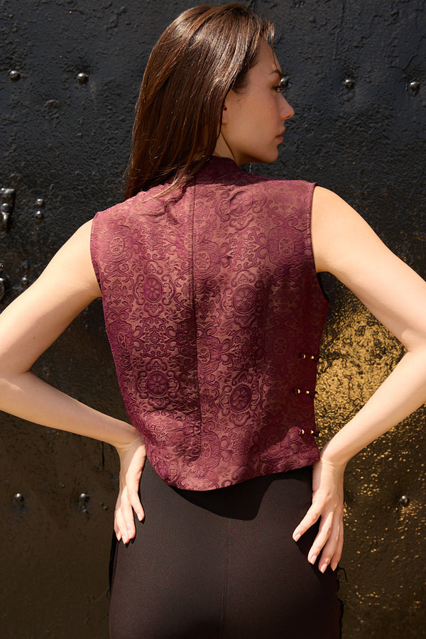 Back view of a woman wearing Du & Berry Jacquard Mulberry Silk Vest in Burgundy with intricate floral pattern