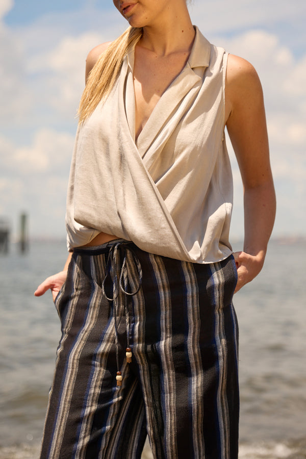 Du & Berry navy linen wide leg stripe pants with drawstring waist worn by woman at beach