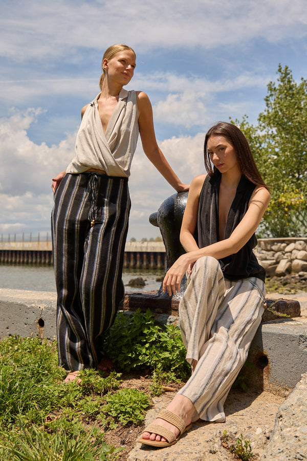 Du & Berry Navy Linen Wide Leg Stripe Pants worn by two women in a sunny outdoor setting near water