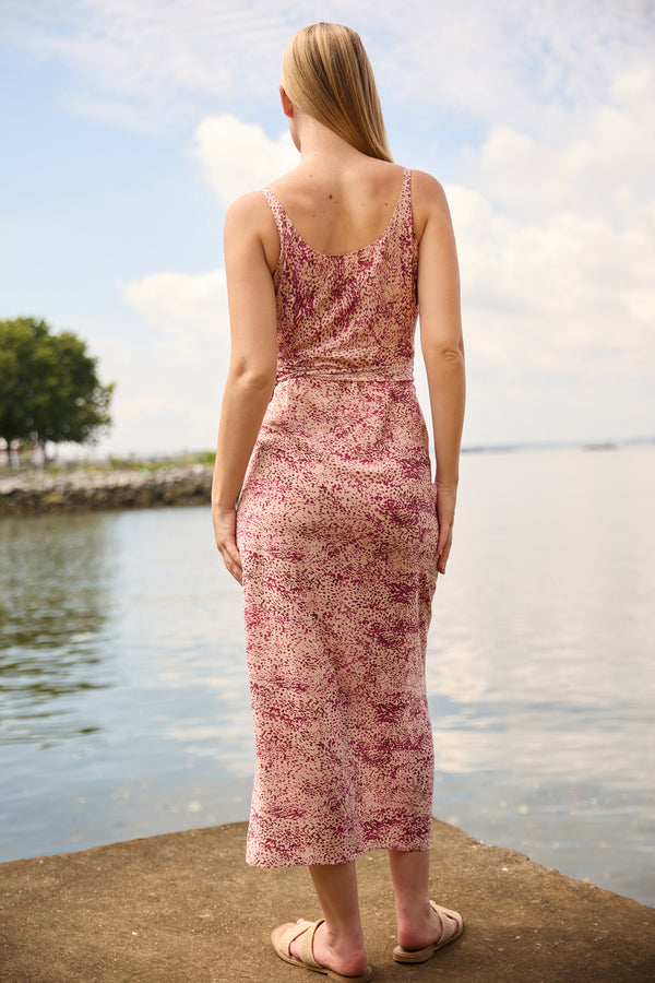 Du & Berry convertible silk wrap dress in pink floral print worn by woman standing by the water