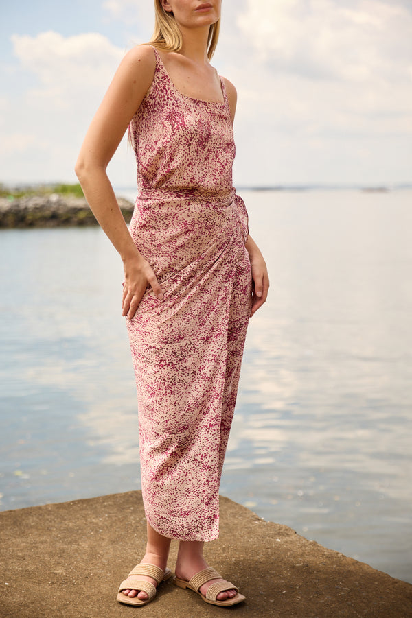 Du & Berry convertible silk wrap dress in pink leopard print with sleeveless design by the water