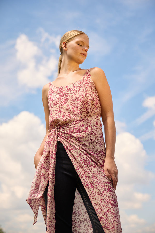 Du and Berry convertible silk wrap dress in pink floral pattern worn over black pants under blue sky