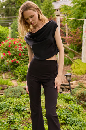 Du & Berry Draped Top in Deep Black worn by model with garden background
