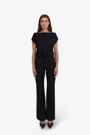 Du & Berry Draped Top in Deep Black worn by model with matching black pants and heels
