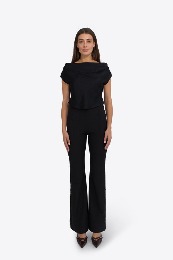 Du & Berry Draped Top in Deep Black worn by model with matching black pants and heels