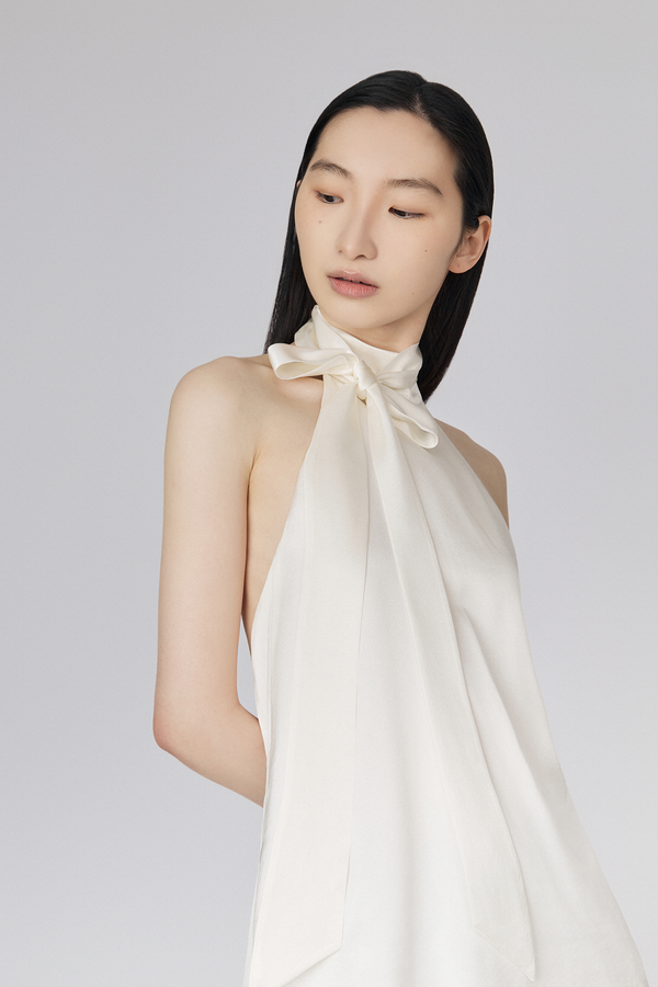 Du and Berry white halter blouse with high neck and bow detail worn by model