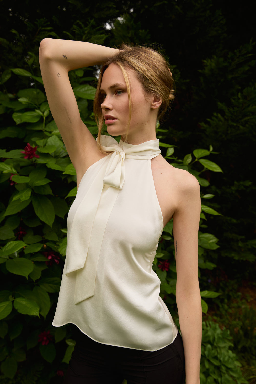 Du & Berry white halter blouse with a neck tie detail worn by a model outdoors